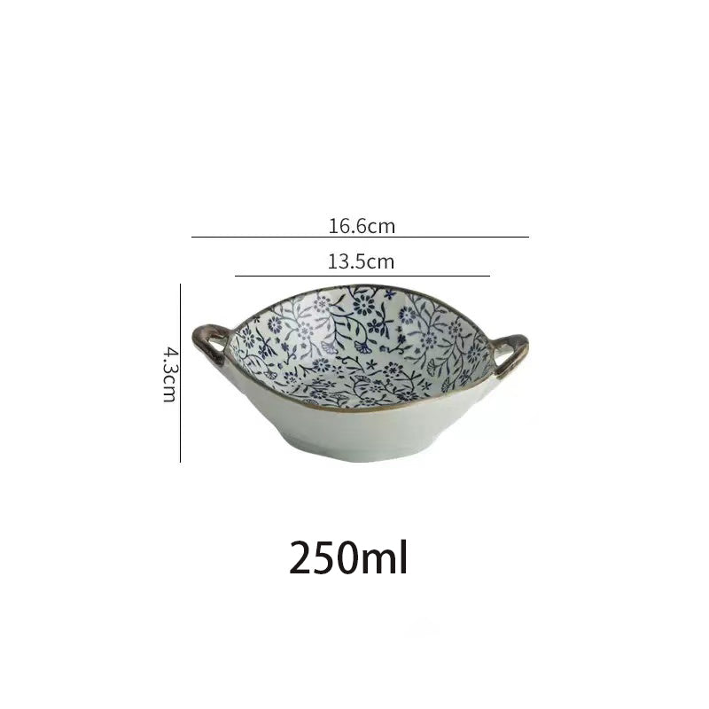 A white ceramic bowl with blue floral patterns and two side handles, shown with overlaid dimensions (16.6 cm width, 13.