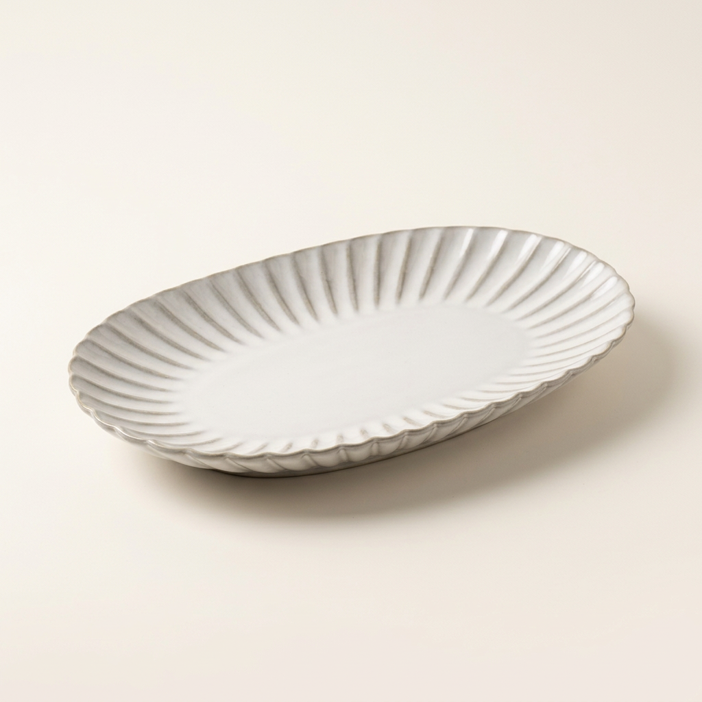 Aiko oval plate in an angled view on a plain warm off-white background