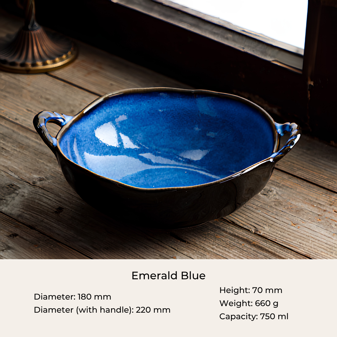 A ceramic bowl with a glossy emerald blue interior and a dark brown exterior, shown on a rustic wooden surface near a window. Text at the bottom reads 'Emerald Blue' with dimensions and capacity details.