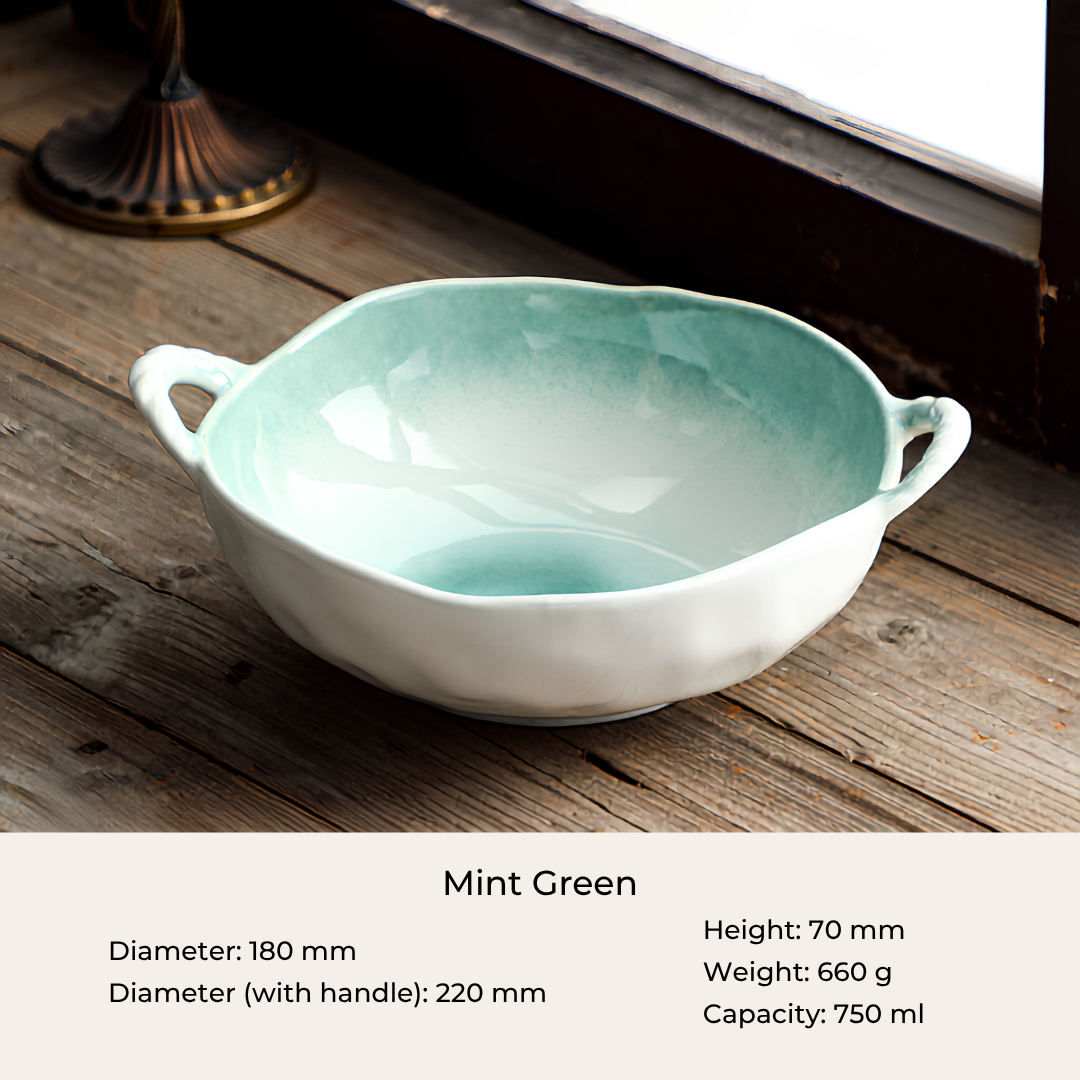 A ceramic bowl with a mint green glazed interior and a white exterior, shown on a rustic wooden surface. Text at the bottom provides dimensions, weight, and capacity for the bowl.